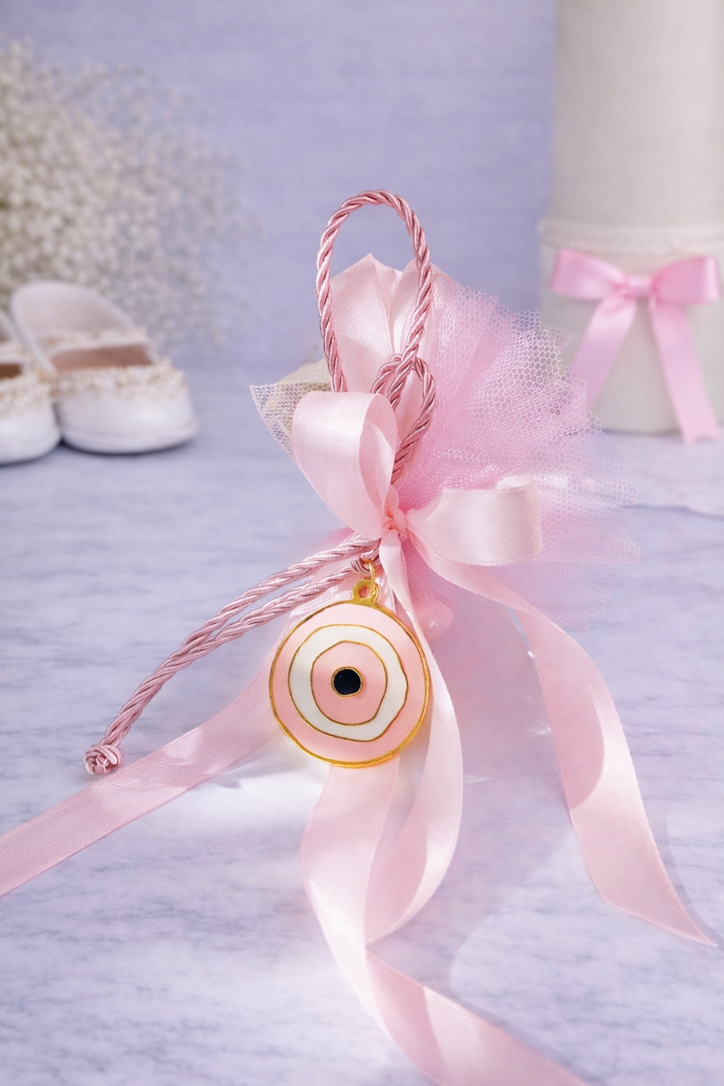 Ροζ μπομπονιέρα βάπτισης με σατέν κορδέλες και χρυσό μεταλλικό ματάκι